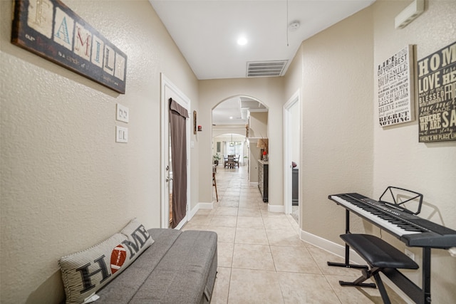 hall featuring light tile patterned floors