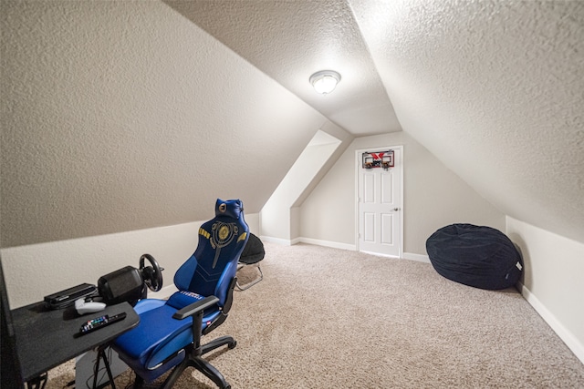 carpeted home office with lofted ceiling and a textured ceiling