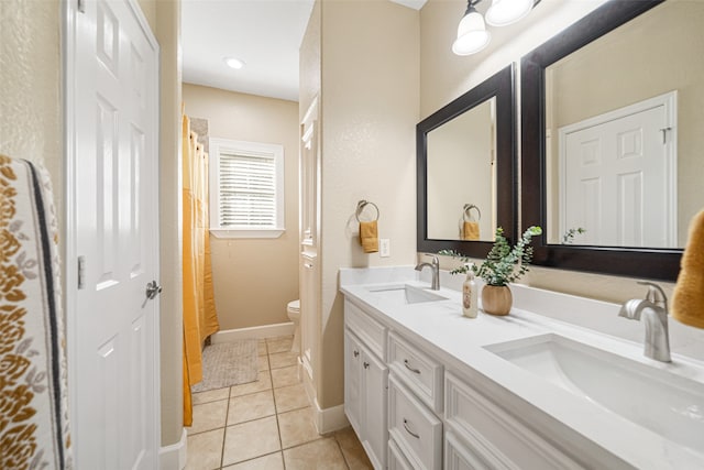 bathroom with tile patterned flooring, vanity, and toilet