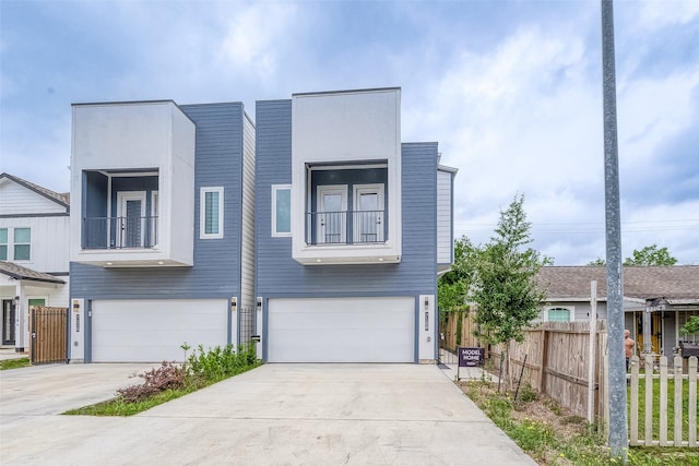 view of front of house featuring a garage and a balcony