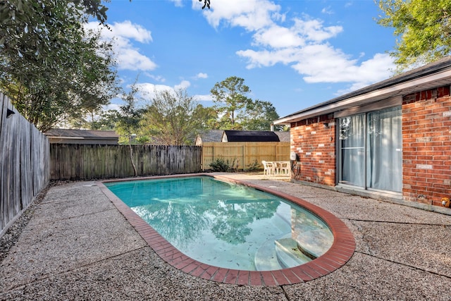 view of swimming pool featuring a patio area