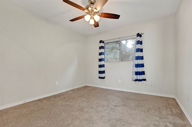 spare room featuring carpet and ceiling fan