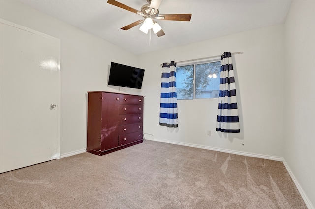 unfurnished bedroom with ceiling fan and carpet