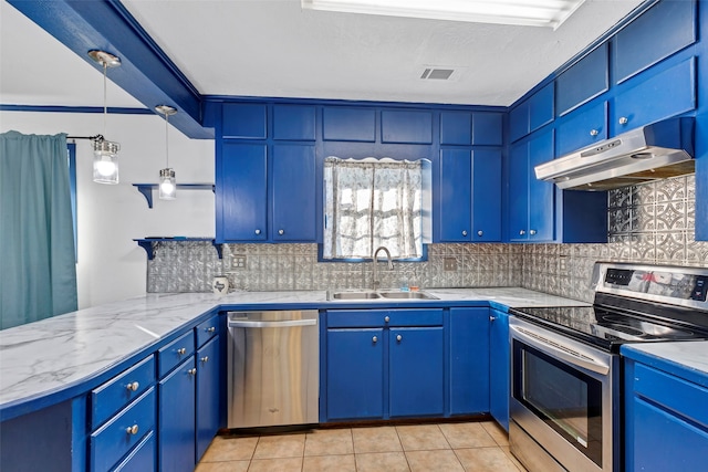 kitchen featuring decorative backsplash, hanging light fixtures, light tile patterned floors, blue cabinetry, and appliances with stainless steel finishes