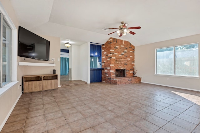 unfurnished living room with lofted ceiling, light tile patterned floors, ceiling fan, and a fireplace