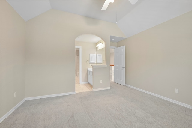 unfurnished room featuring lofted ceiling, light carpet, and ceiling fan