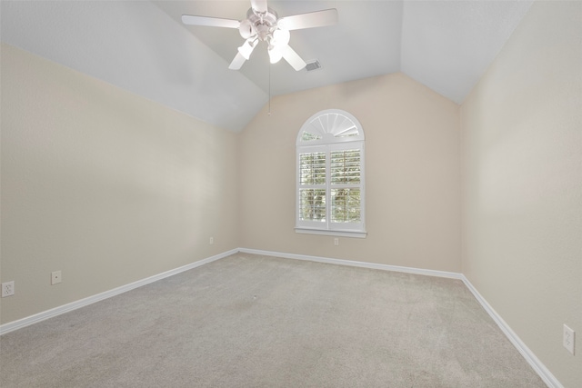 empty room with lofted ceiling, light carpet, and ceiling fan