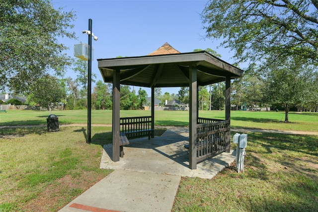 view of home's community with a lawn and a gazebo