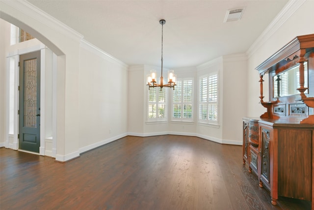 unfurnished dining area with ornamental molding, dark hardwood / wood-style flooring, and a chandelier