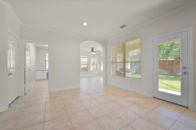 tiled spare room with ceiling fan and crown molding