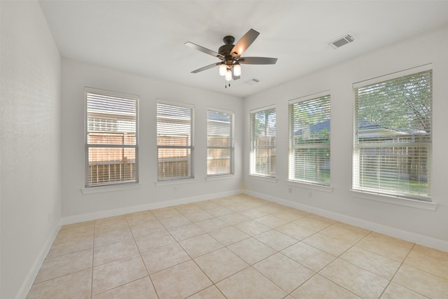 unfurnished sunroom with ceiling fan