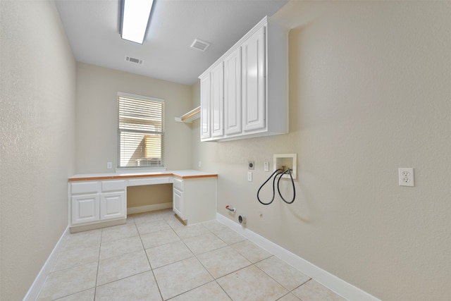 washroom with hookup for an electric dryer, hookup for a washing machine, hookup for a gas dryer, light tile patterned floors, and cabinets