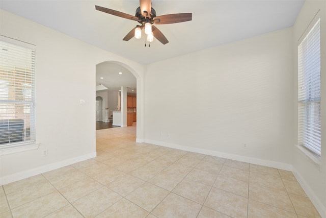 unfurnished room with light tile patterned floors and ceiling fan