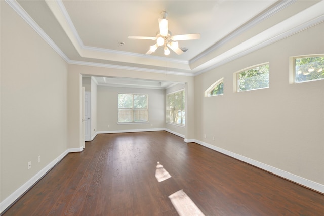 unfurnished room featuring ornamental molding, a raised ceiling, dark hardwood / wood-style floors, and ceiling fan