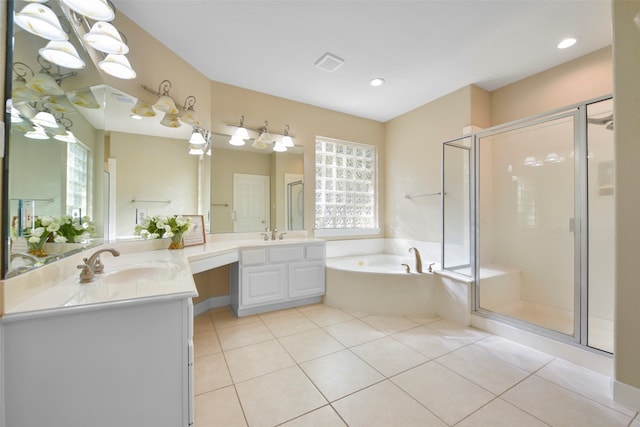 bathroom with vanity, tile patterned floors, and plus walk in shower