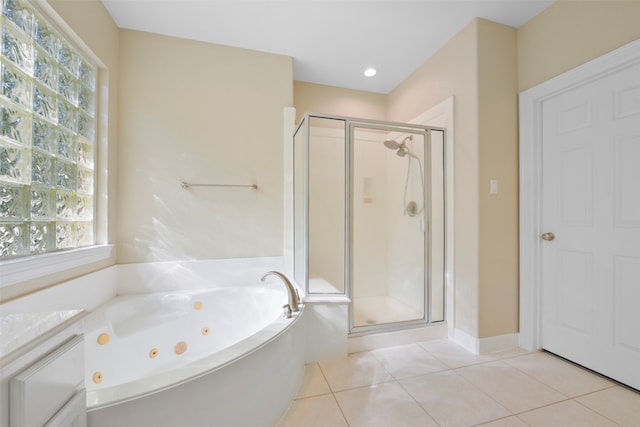 bathroom with tile patterned floors and independent shower and bath