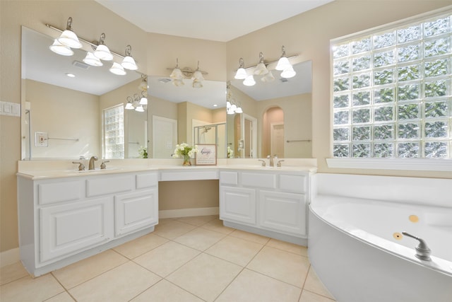 bathroom with vanity, an inviting chandelier, tile patterned flooring, and plus walk in shower