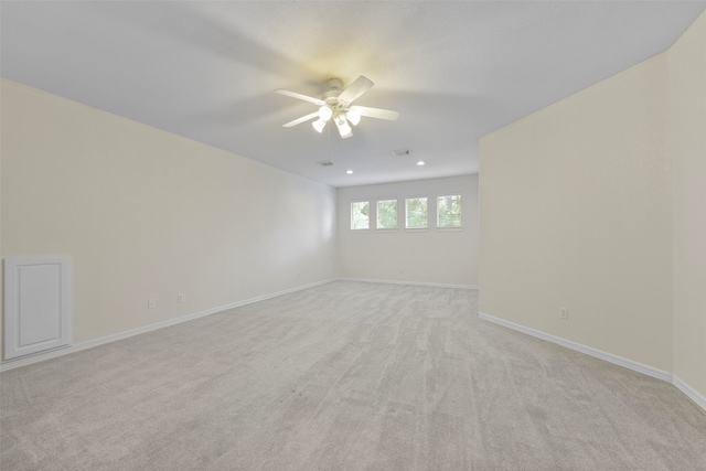 carpeted spare room with ceiling fan