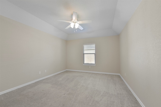 carpeted empty room with ceiling fan and vaulted ceiling