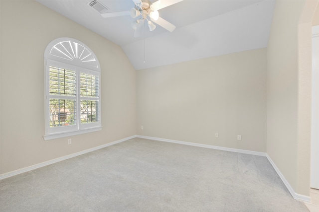 carpeted spare room with ceiling fan and lofted ceiling