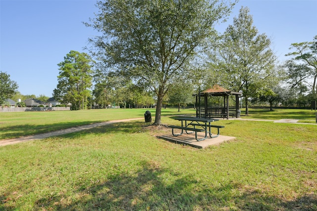 surrounding community with a yard and a gazebo