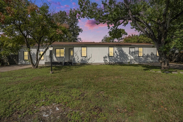 manufactured / mobile home featuring a yard and a porch