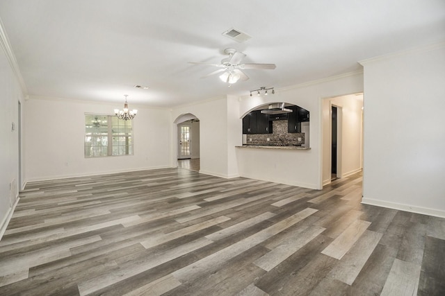 unfurnished living room with hardwood / wood-style floors, ceiling fan with notable chandelier, and crown molding