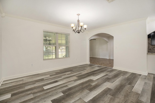 unfurnished dining area with dark hardwood / wood-style floors, crown molding, and a notable chandelier