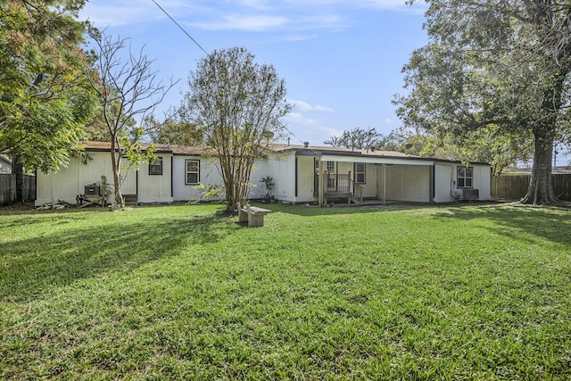 rear view of house with a yard