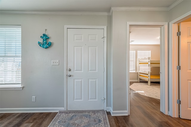 entrance foyer with dark hardwood / wood-style flooring and ornamental molding