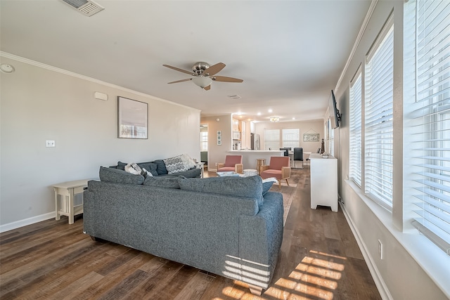 living room with ornamental molding, dark hardwood / wood-style floors, and ceiling fan