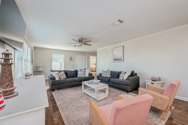 living room featuring dark wood-type flooring, ornamental molding, and ceiling fan