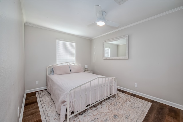 bedroom with hardwood / wood-style flooring, ornamental molding, and ceiling fan