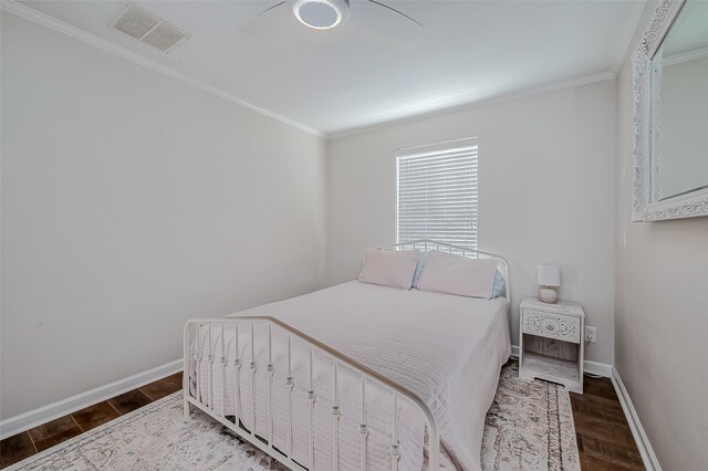 bedroom featuring ceiling fan, ornamental molding, and wood-type flooring