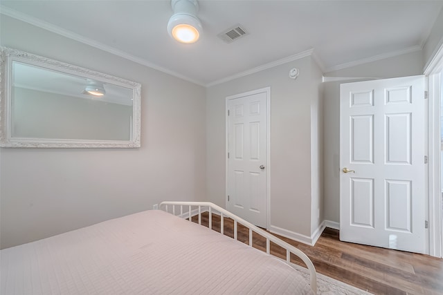 unfurnished bedroom featuring wood-type flooring and ornamental molding