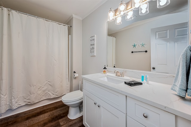 bathroom with toilet, vanity, hardwood / wood-style floors, and crown molding