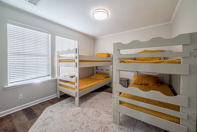 bedroom with dark hardwood / wood-style flooring and ornamental molding