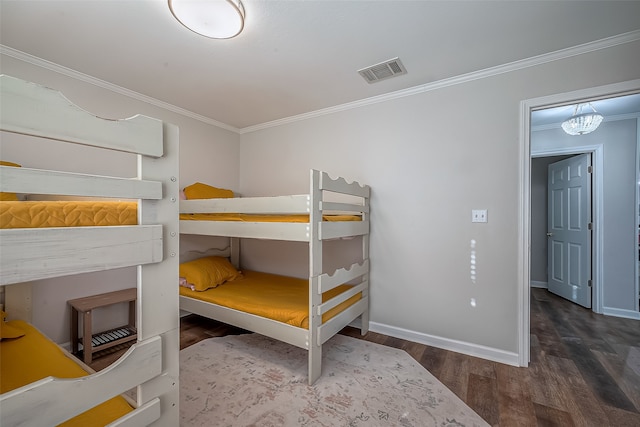 bedroom featuring a chandelier, hardwood / wood-style floors, and crown molding