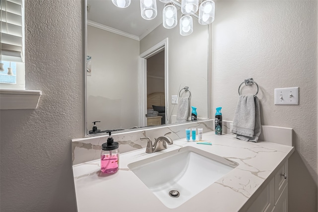 bathroom with vanity and ornamental molding