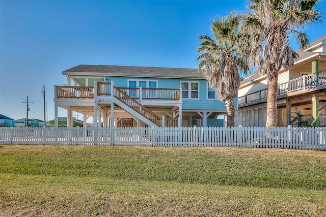 view of front of home featuring a deck and a front yard