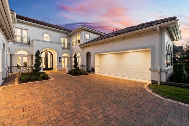 mediterranean / spanish home featuring a garage