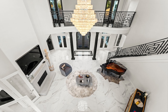 living room featuring a chandelier and a high ceiling