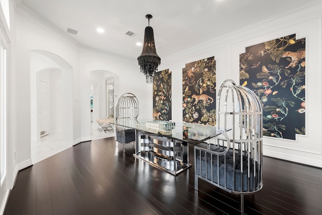 dining space with dark hardwood / wood-style floors, a chandelier, and ornamental molding