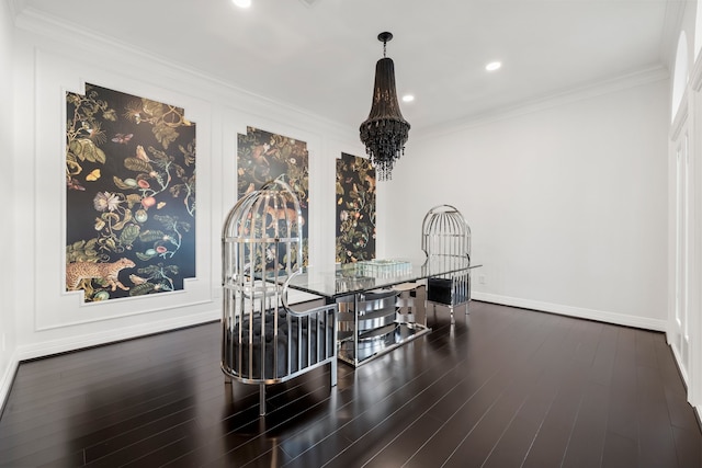 dining area with ornamental molding, dark hardwood / wood-style floors, and an inviting chandelier