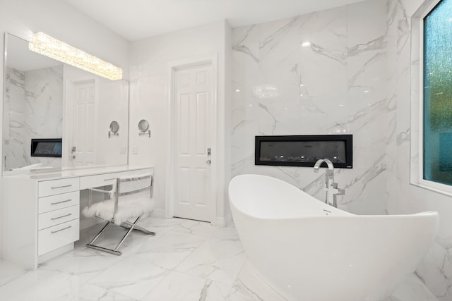 bathroom featuring a washtub and vanity