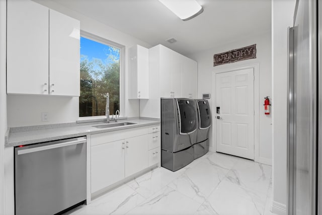 laundry area with cabinets, sink, and independent washer and dryer