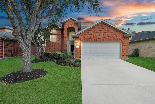 view of front property with a lawn and a garage