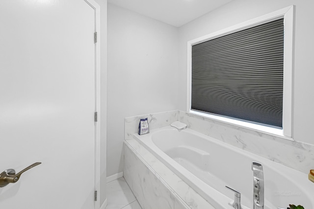 bathroom featuring tile patterned flooring and a bath