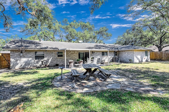 back of house with a patio area and a yard