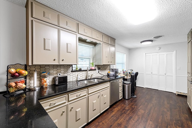 kitchen with decorative backsplash, a textured ceiling, sink, dishwasher, and dark hardwood / wood-style floors